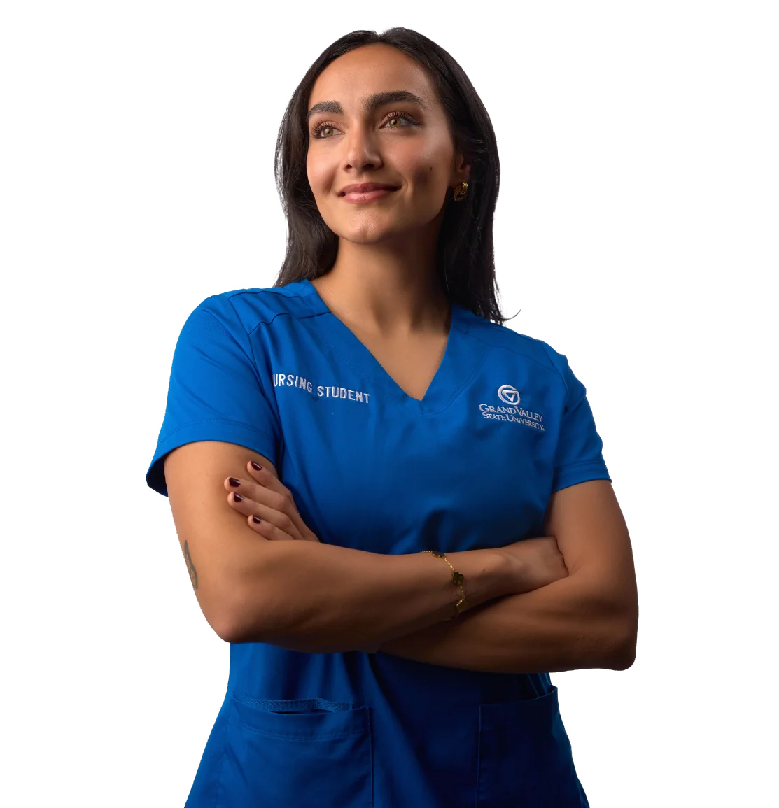 Nursing student in blue scrubs with arms crossed